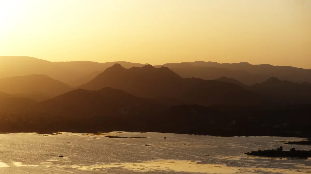 Lake Pichola in Udaipur with the City Palace along the shore and hills behind
