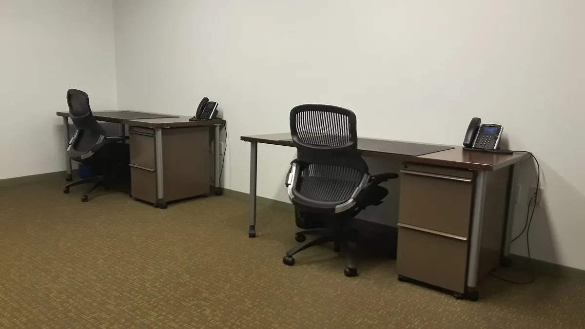 An empty office floor with bare walls and windows, ready for fit-out